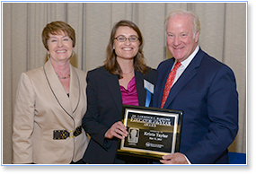 Krista Taylor (center) was presented her  "Educator of the Year" award by Cincinnati  Public Schools Superintendent Mary Ronan  and Western & Southern CEO John Barrett