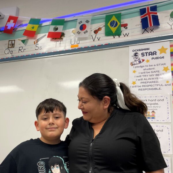 Jacqueline Cacique beams at her son Christopher, 9, under the Mexican flag in an Early Learner classroom at Ockerman Elementary. 
