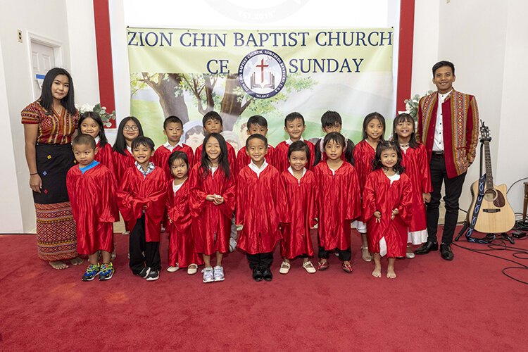Members of Zion Chin Baptist Church gather before a Sunday church service in September. It is one of two Northern Kentucky churches serving the sizable population of Chin refugees from Myanmar (Burma). Photo Joe Simon.