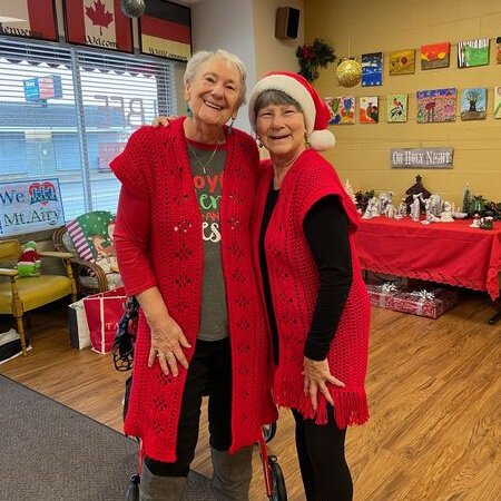 LBFE Friend Dolores Allman (left) and longtime volunteer Kathy Eby strike a whimsical holiday pose. From Thanksgiving to New Year's, those who live in isolation (senior citizens in particular), are particularly prone to depression.