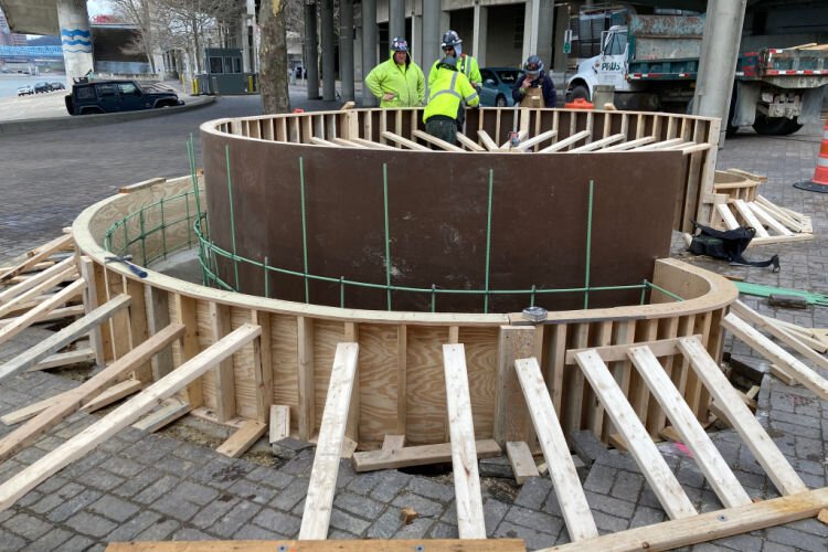 Mark Kroell and the Prus Construction crew begins the construction of the 20-foot concrete bench.