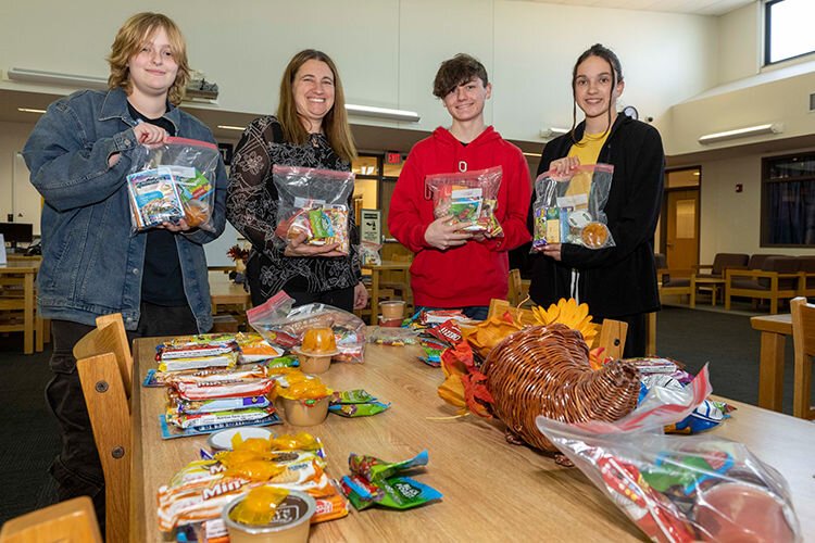 Helping Hands for the Homeless "survival kits". L to R: Jean Adkins, Jodi Petersime, Declan Sefton, and Mason Heitman.