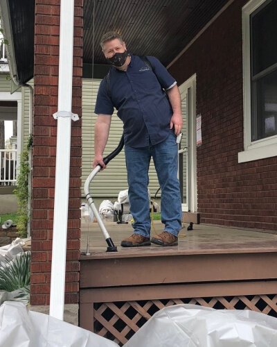 Steve McNamee, PWC project manager and lead abatement contractor, using a specialized HEPA vacuum to clean up a lead abatement project site.