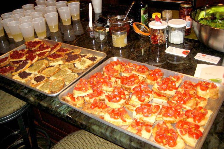 Students make bruschetta during a cooking class.
