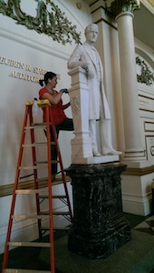 Careful restoration of a statue in Springer Auditorium