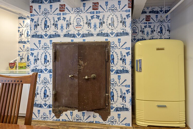 The first occupant of 2429 Gilbert, Bolce Paints, was paid homage through many elements of the building, including this meeting room adorned with Bolce-themed wallpaper and paint cans decorated with recreations of its erstwhile labels.