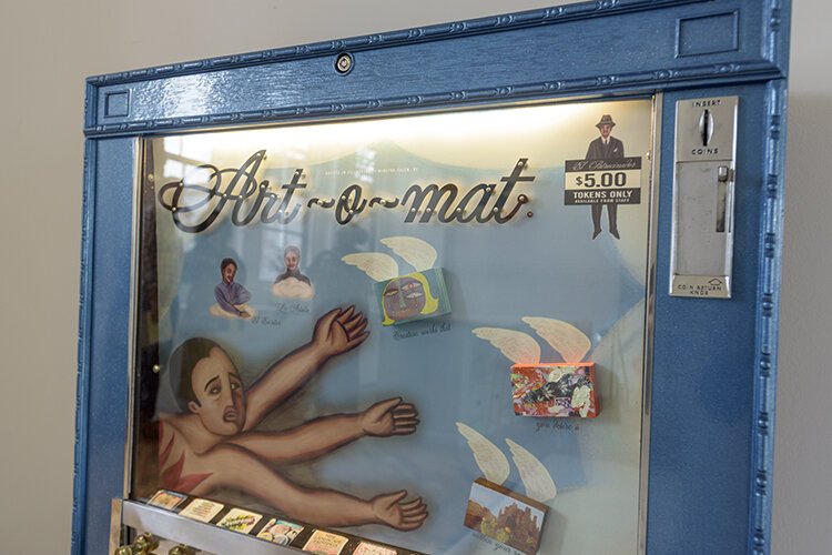 An Art-O-Mat, resembles a cigarette machine. But, instead of dispensing tobacco, it ejects $5 artwork produced by local talent.
