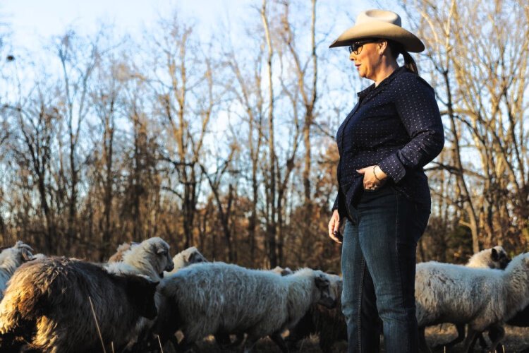 Sarah Ison, who co-owns Flourish and Roam in Moscow with her husband, Josh, stands in the field with their flock of sheep. Intentional cover-crop planting and rotational grazing are among the methods they use to operate an organic farm.