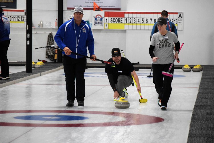 The Cincinnati Curling Club hosted a 16-team tournament last November with clubs from within Ohio and out of state. Here Eric Reardon delivers his stone while Philip Stafford and Cathy McKee follow it and are ready to sweep.