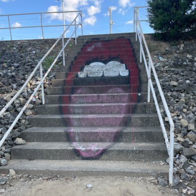 Art trips down the stairs from the nondescript parking lot to the landing with the incredible view. 