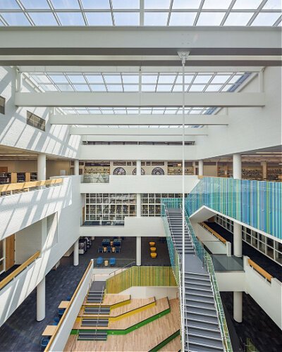 A panoramic view around the social staircase, which showcases the enhanced skylights that are part of its energy efficiency improvements. 