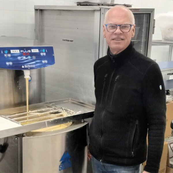 Paul Picton stands beside a mixer that blends white chocolate at Maverick Chocolate’s Rookwood location. Paul started Cincinnati's only bean-to-bar chocolate shop as a growth of his passion for bringing gourmet chocolates home from trips abroad. 