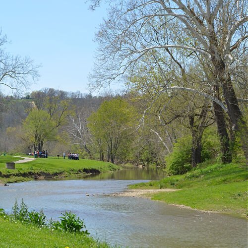 Banklick Creek winds through soft green hills in Pioneer Park in Covington.