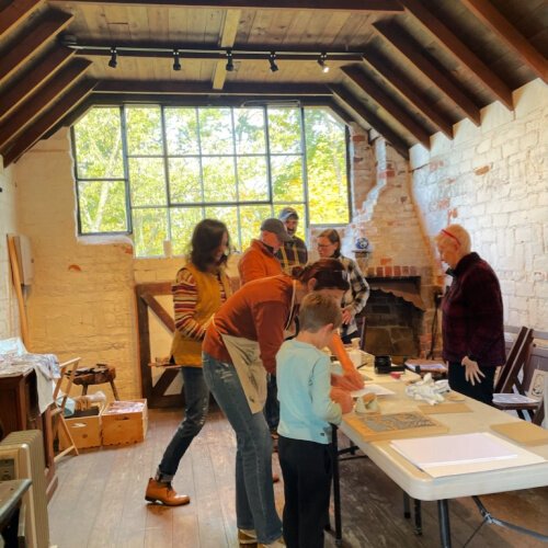 Printmaking workshop guests inside the Hubbard House Studio.