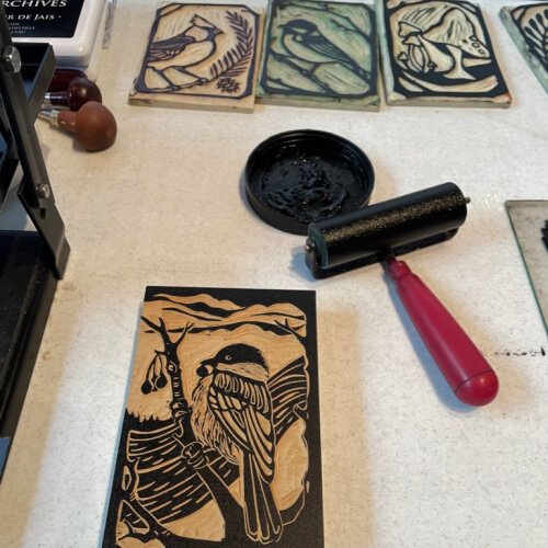 Carved wooden blocks included carvings of birds, one of mushrooms, a snail, and a pair of barn owls. 