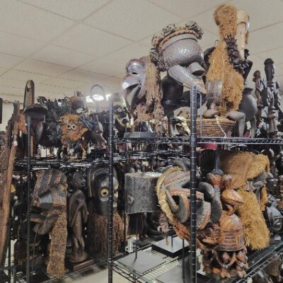 Rows of face masks and games greet visitors in the upper gallery space.