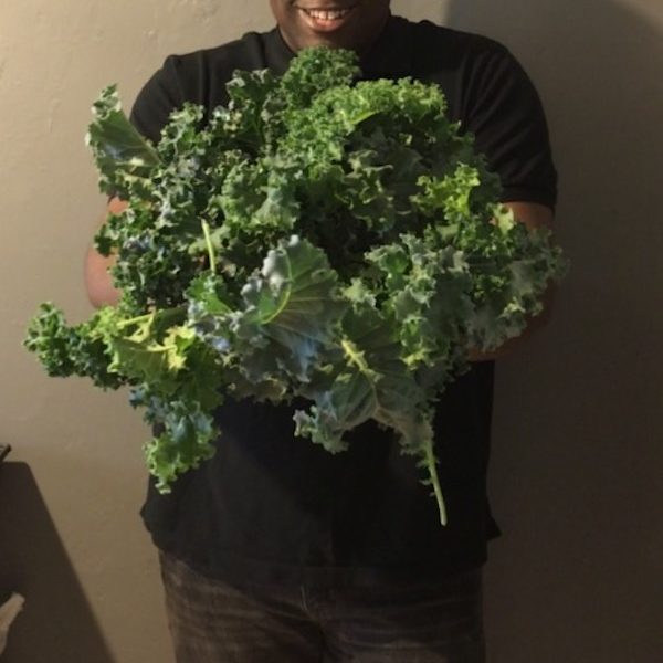 Domonique Peebles with a harvest from his People's Liberty project, Brick Gardens.