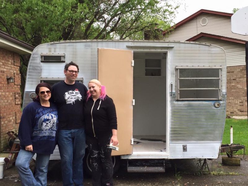 Janet Creekmore, Ben Jason Nel and Melissa Mitchell with their vintage camping trailer before it became a mobile art gallery.