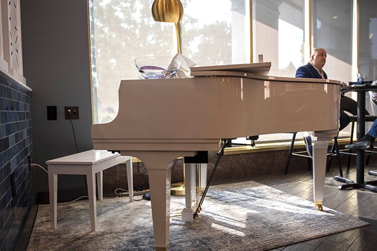 Ivory House's white grand piano