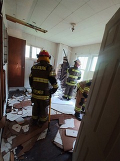 Firefighters from Melbourne training inside the Silver Grove home on Saturday.