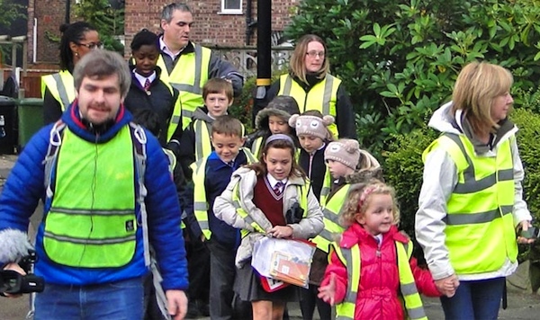 Walking School Bus used volunteers to help "conduct" students to and from several Cincinnati public schools.