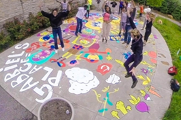 Avondale residents & helpers jump for joy after finishing painting project at Gabriel's Place