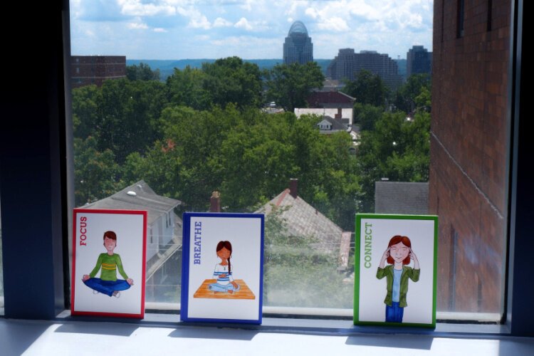 MindPeace prompts rest on a windowsill overlooking downtown Cincinnati. The view is a reminder that most youth will return to the community; the question is how prepared will they be.