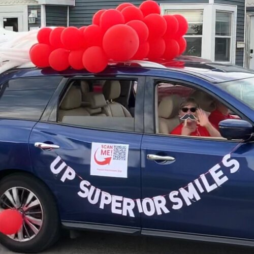 Lynda Gregorini showcases her school-based dental care nonprofit at a community parade.