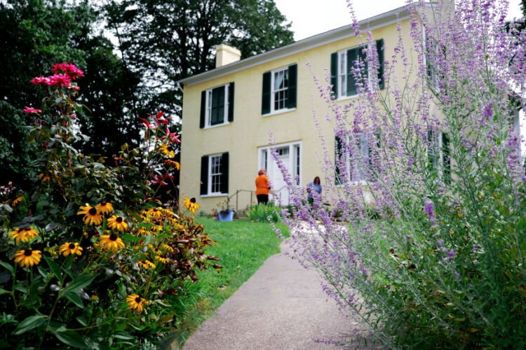 Volunteers tend to the Harriet Beecher Stowe House gardens, where native plants are being  reintroduced to restore ecological and historical memory.